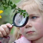 Child with magnifying glass